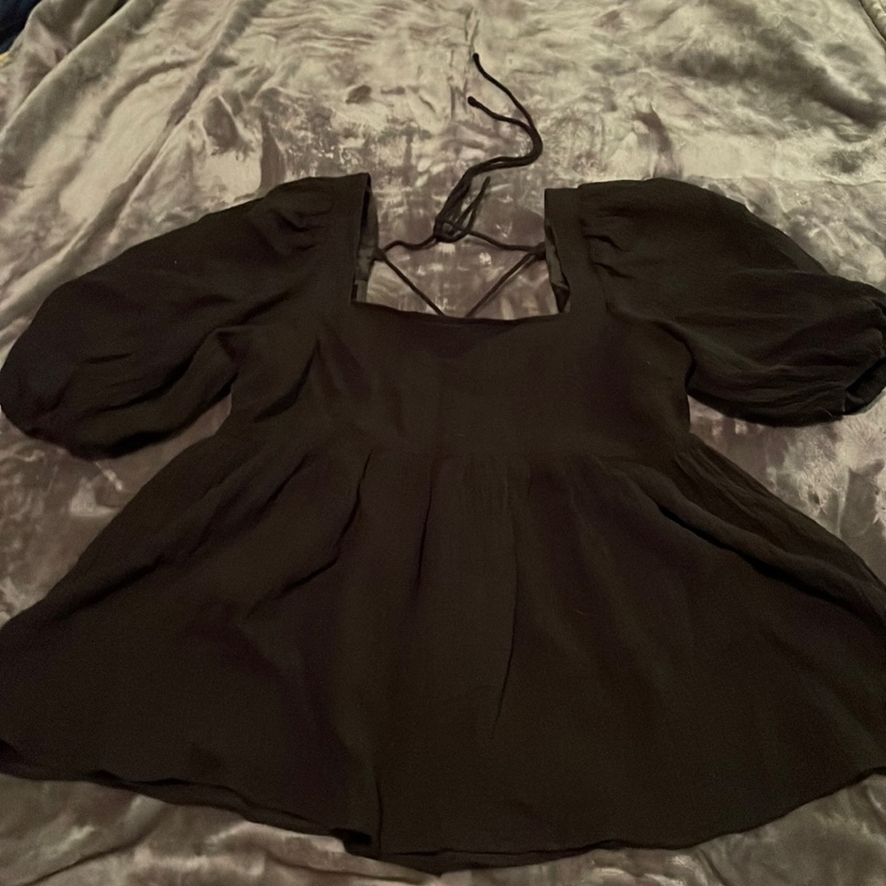 Black peplum style top with puffy sleeves